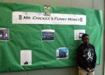 Derrald poses in front of his board depicting Flint locations in Mr. Chickee's Funny Money