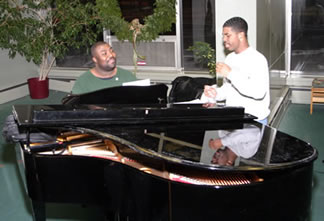 2 singers practicing a grand piano.