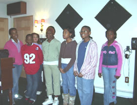 Children singing, standing in a row. 
