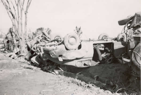 Car upside down over ditch. 