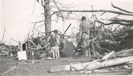 Children standing and looking at debris. 