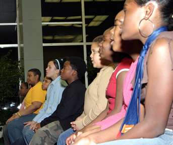 Group photo of seated choir members singing. 