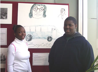 Two children standing in front of large drawing.