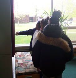 Children reading descriptions of exhibit photos.