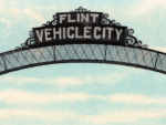 A close up shot of the Flint Vehicle City sign on the downtown Flint Arches