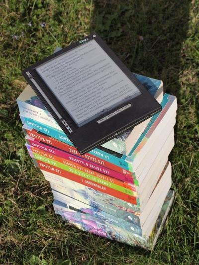Stack of Books with eReader on top.