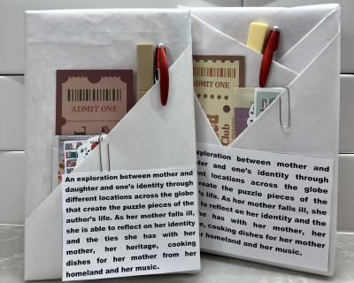 Photo of books wrapped with brief descriptions, packaged with tea bags, pen and stickers.
