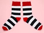 Photo of pair of black and white striped socks with red accents
