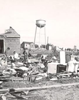 Tornado damage with water tower in background