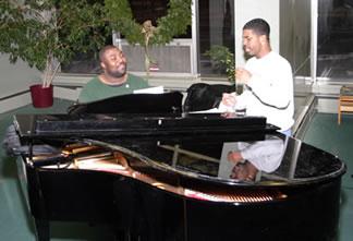 2 singers practicing a grand piano. 