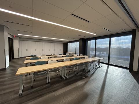 Photo of meeting room with three rows of tables and chairs set classroom style.